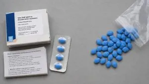 Genuine prescription sildenafil packaging compared with counterfeit Viagra tablets sold without a valid prescription